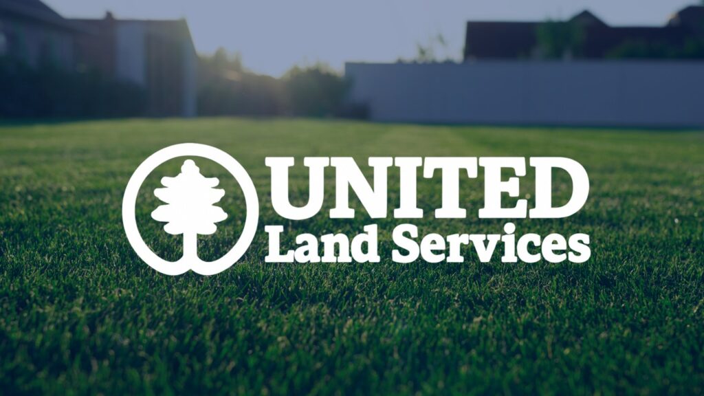 Grass lawn with United Land Services Logo